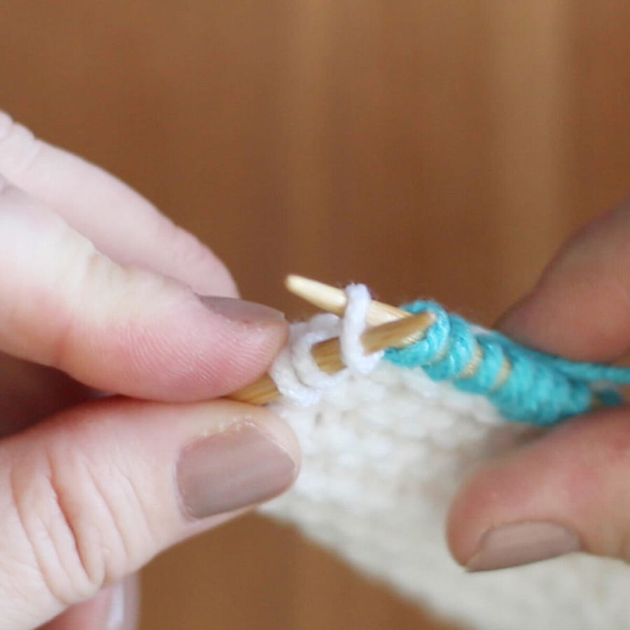 Close-up view of a knitted fabric showing the Kfb knitting technique