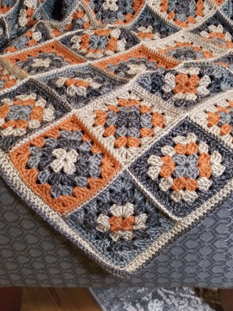 Colorful granny square blanket made from leftover yarn